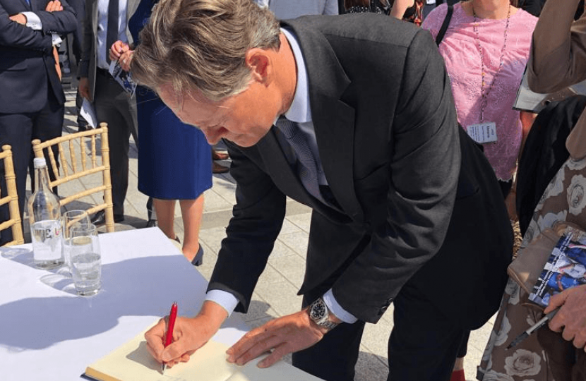 Matthew Offord signing the visitors book at Chase Farm Hospital